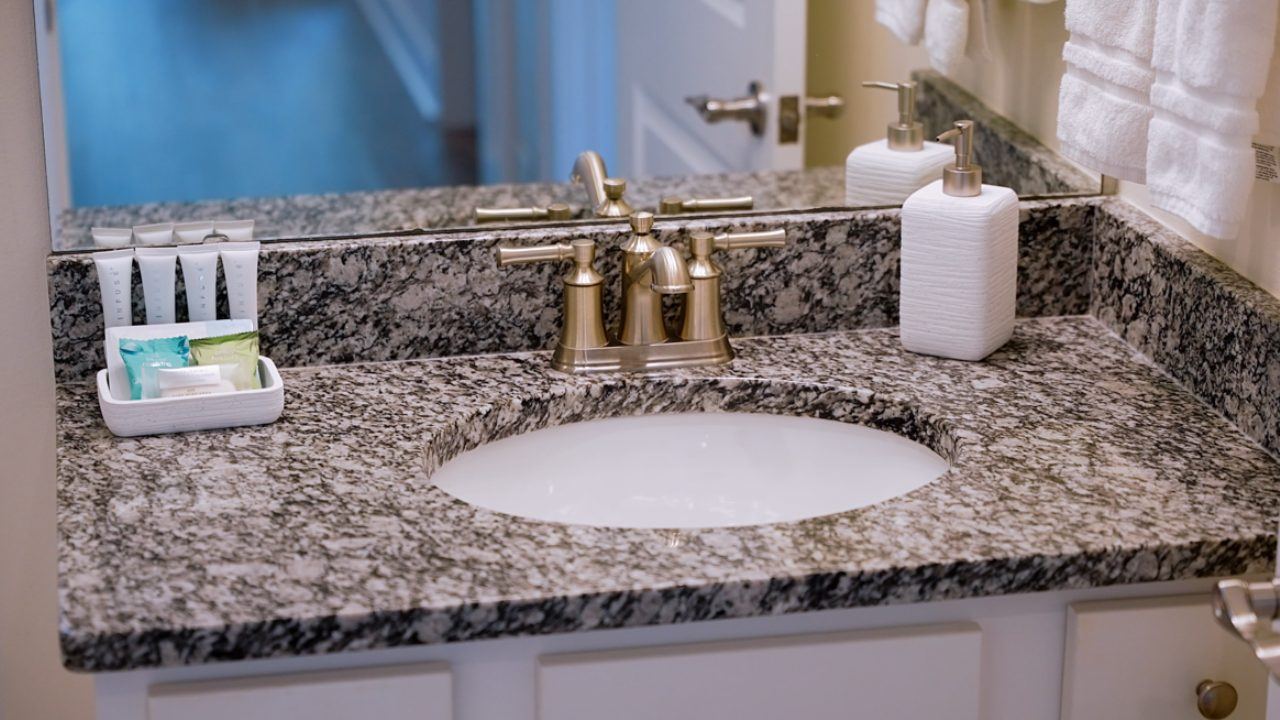 Bathroom with walk-in glass shower and granite vanity