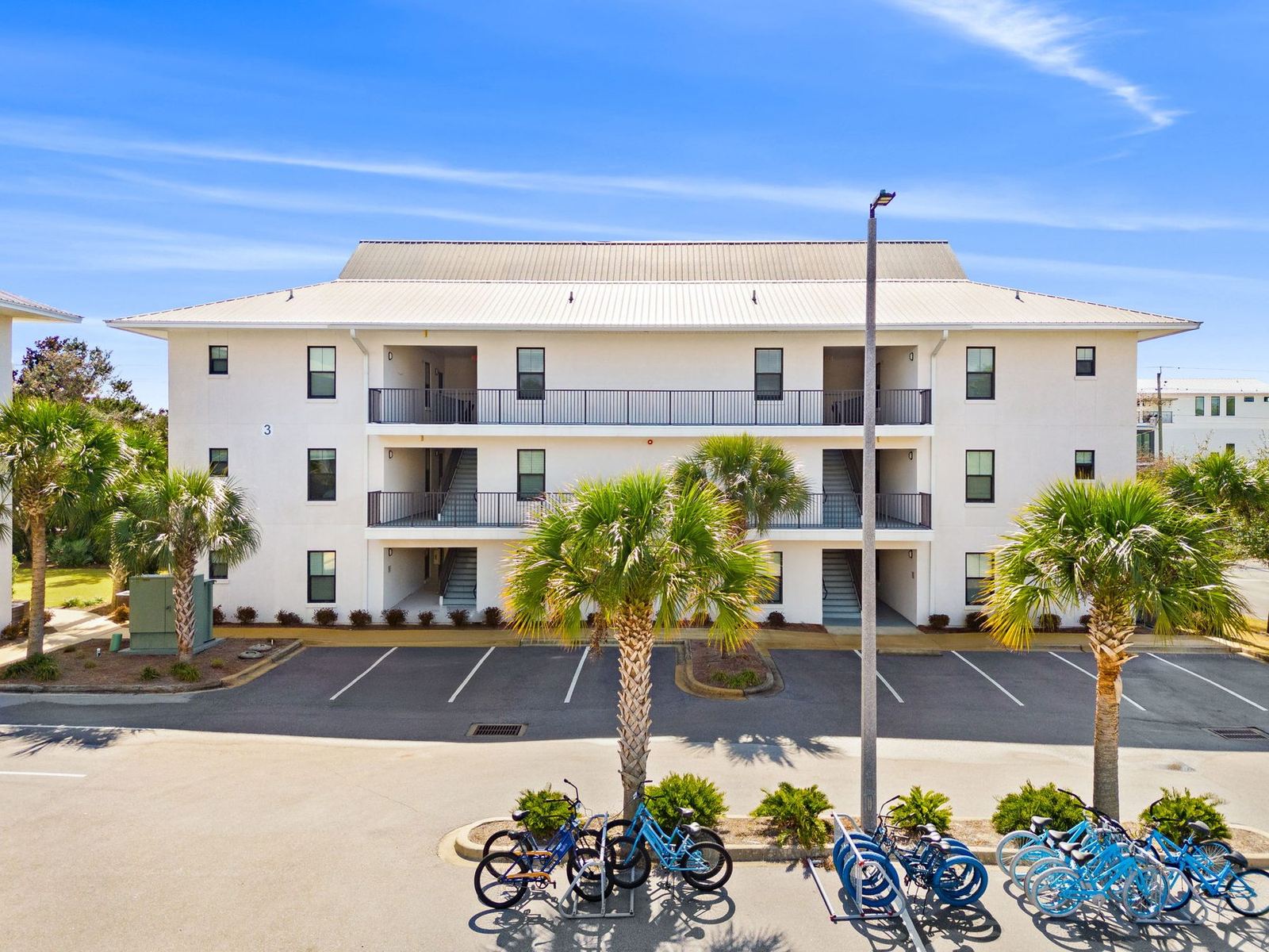 Cheeks on the Beach building exterior with palm trees and bikes